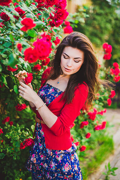 istock beautiful girl and red roses 508786337