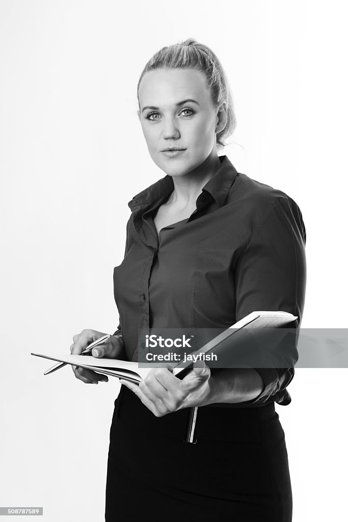 working hard standing business woman working and checking or making note in a large note pad Adult Stock Photo