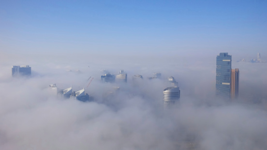 Dubai, United Arab Emirates - April 7, 2014: Dubai Media City and Dubai Marina is covered by early morning fog in Dubai, UAE.