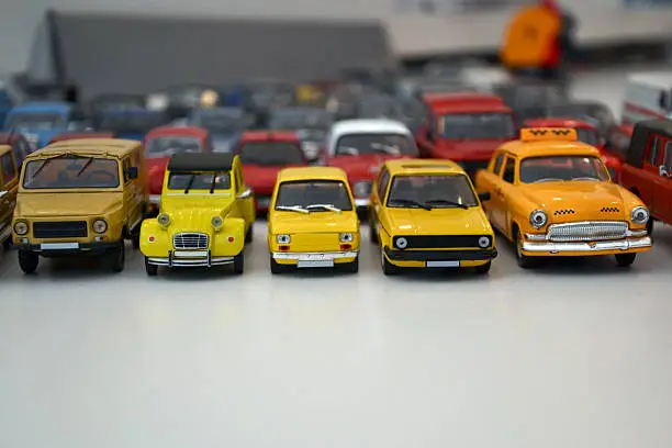 Collectors car models in scale 1/43 in a row on a table.