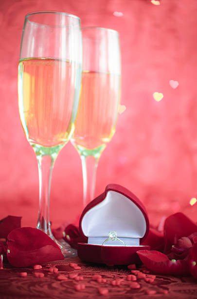 istock Still life with champagne, gift box and red rose petals 508788894