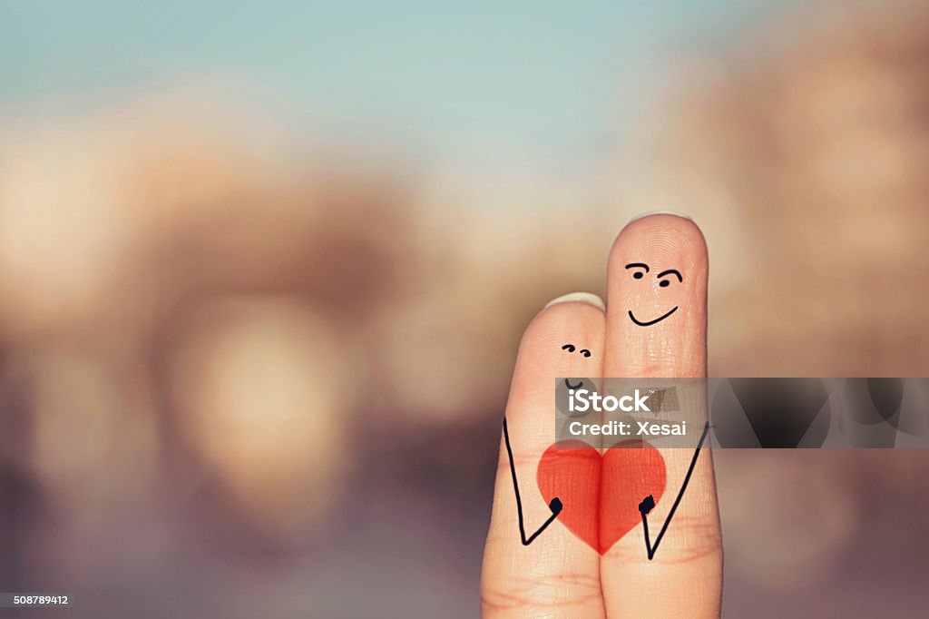 Happy loving fingers holding red heart Drawing - Activity Stock Photo