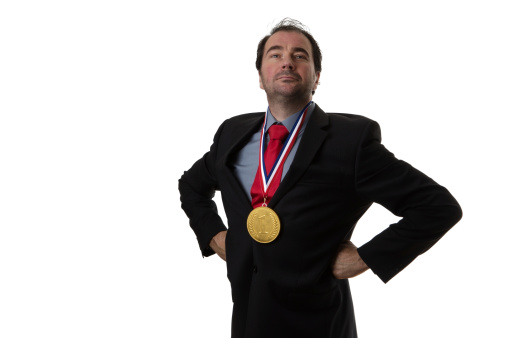 Business man wearing a chocolate gold medal around his neck