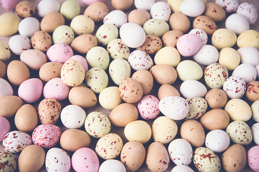 Easter pastel speckled eggs, selective focus background, toning