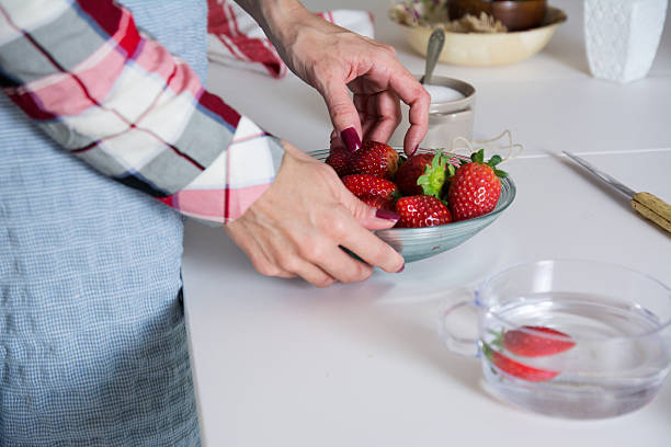 istock Woman putting strawberries on plate 508792822