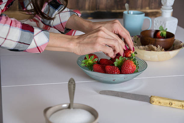 istock Woman putting strawberries on plate 508792926