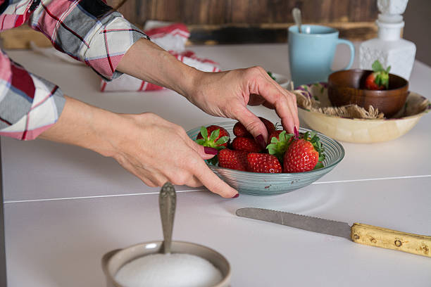 istock Woman putting strawberries on plate 508792958