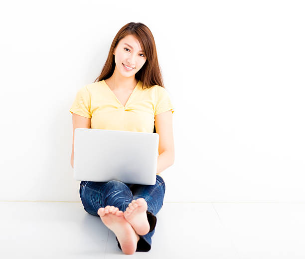 istock Smiling seated young woman with laptop 508792970
