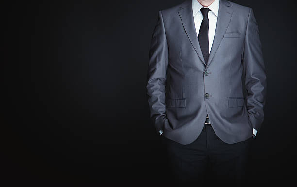 istock Businessman standing full suit on black background 508795204