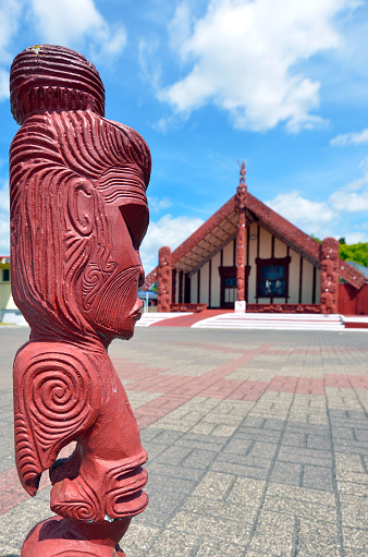 Rotorua, New Zealand - January 12, 2015: Maori carving statue in Te Papaiouru Marae, Rotorua, New Zealand. It's one of the most important meeting houses in New Zeland many significant people have been welcomed onto Te Papaiouru Marae, including British royalty.