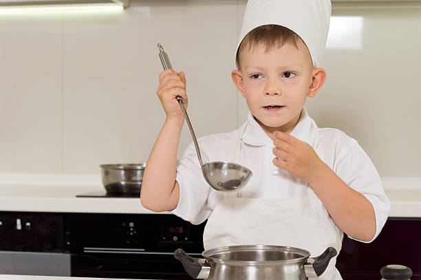 istock Cute young chef tasting his cooking 508796240