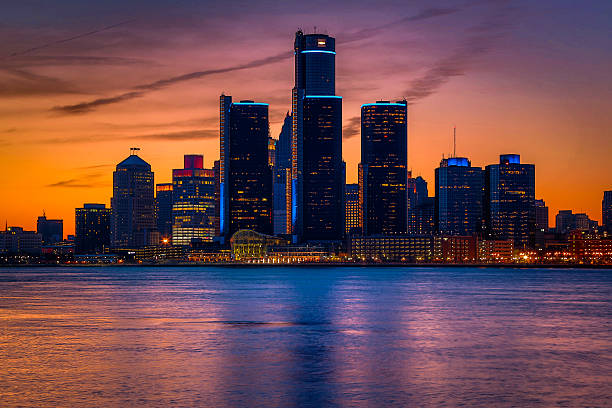 Detroit Skyline at Golden Hour View of Detroit from Windsor, Ontario during a golden sunset. detroit michigan stock pictures, royalty-free photos & images