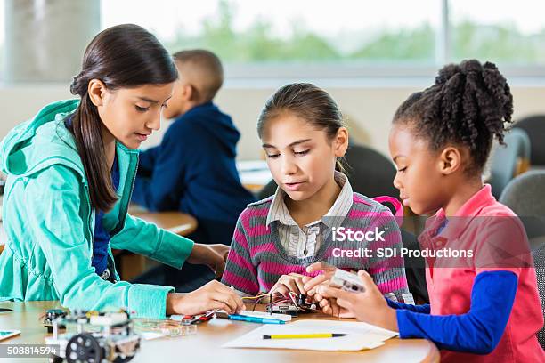 Diverse Elementary Girls Using Robotics Kit In Library Makerspace Stock Photo - Download Image Now