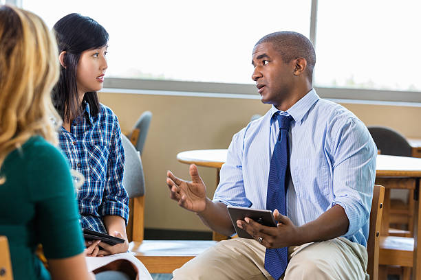 istock Manager discusses project with employees in graphic design firm 508814760