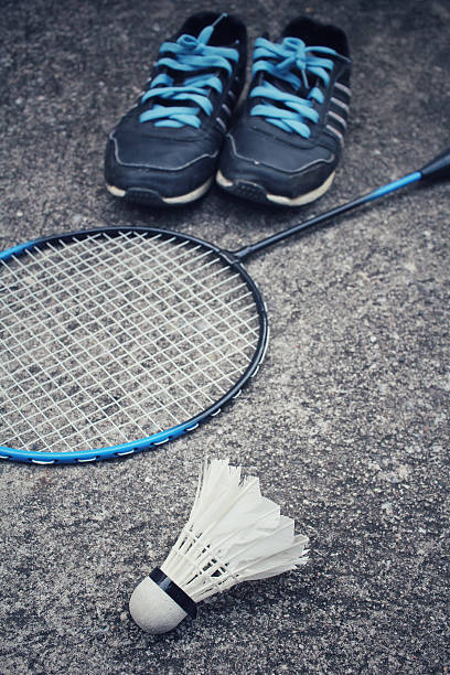istock Sport shoes with shuttlecocks and badminton racket. 508815166