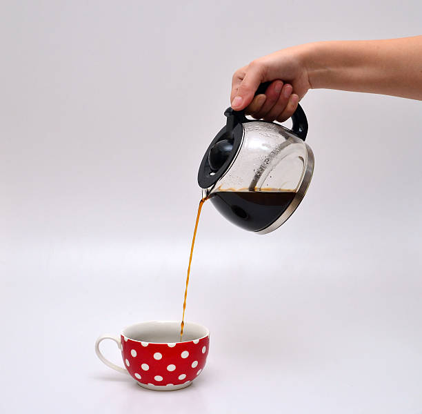 istock woman hand pouring coffee in a mug 508816190