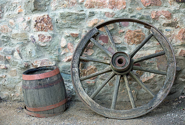 istock Old wooden wagon wheel and barrel 508817848