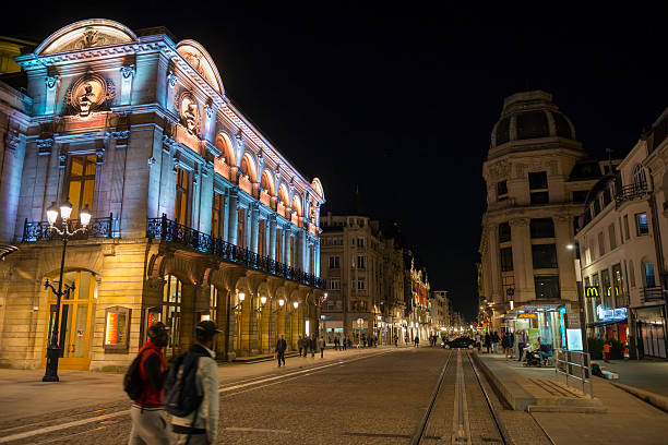 Reims, France - May 16, 2014: People walk on Rue de Vesle at night in Reims.
