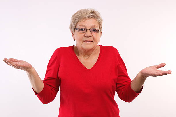 istock Elderly woman shrugging shoulders and throwing up her hands 508819086