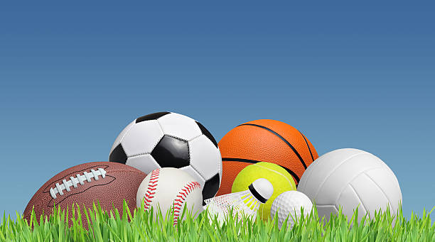 balls balls on a grass field and a blue sky tennis ball container stock pictures, royalty-free photos & images