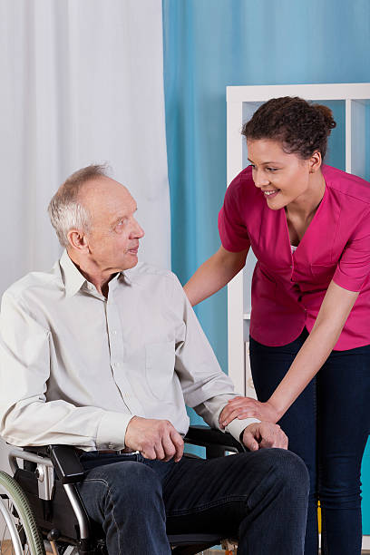 istock Disabled man on wheelchair and nurse 508820197