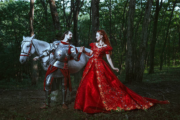 Medieval knight with lady Medieval knight with his beloved lady in red dress queen royal person stock pictures, royalty-free photos & images