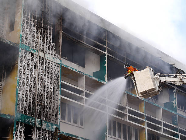 istock Firemen on a crane against wall of fire 508820301