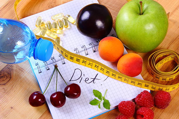 istock Fruits, tablets supplements and centimeter with notebook, healthy food 508820704
