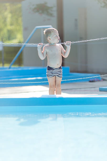 ragazzino nel parco acquatico - wading child water sport clothing foto e immagini stock