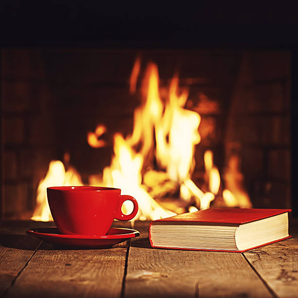 istock Red cup of coffee or tea and old book 508832984