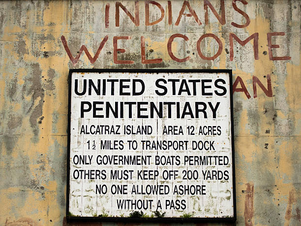 Alcatraz Penitentiary Entrance Alcatraz Island, California, USA: The sign at the entrance of the Alcatraz Penitentiary. Old graffiti during Native american occupation.  alcatraz island stock pictures, royalty-free photos & images