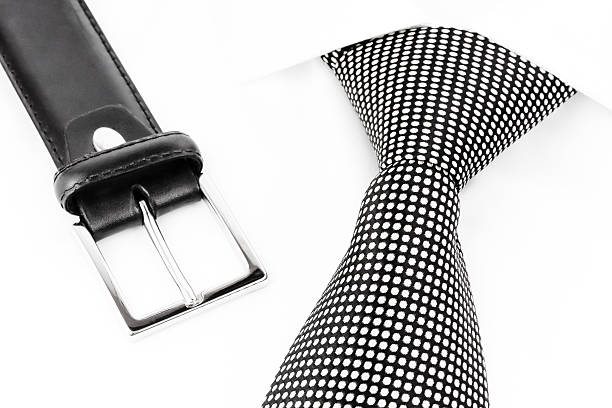 istock black and white spotted tie knotted Windsor and leather belt 508835674