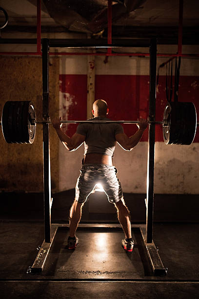 istock Barbell weight lifting man rear view workout gym 508838608