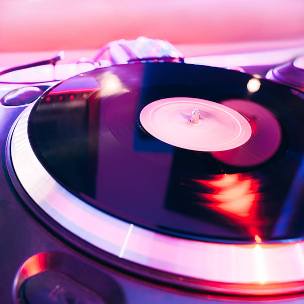 istock Turntable playing vinyl with club lighting 508838868