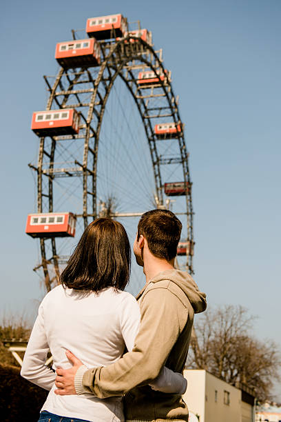 istock Young couple dating in amusement park 508839252