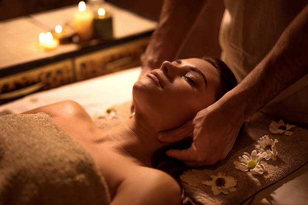 istock Young woman relaxing at spa while receiving head massage. 508839880