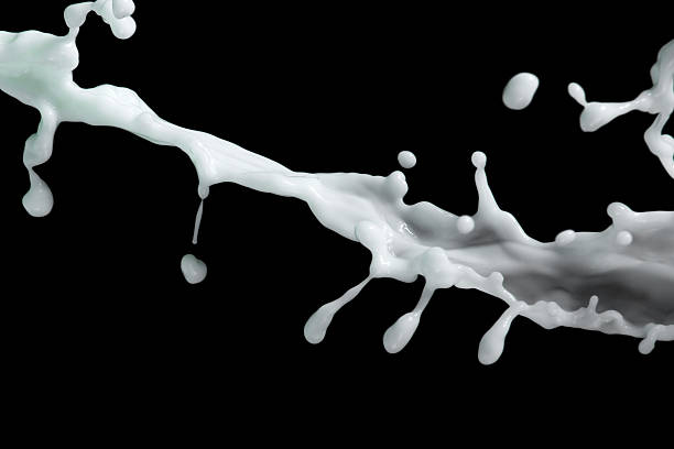 istock milk or white liquid splash on black background 508852124