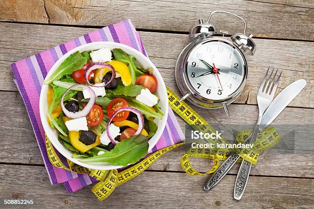 Fresh Healthy Salad And Measuring Tape On Wooden Table Stock Photo - Download Image Now