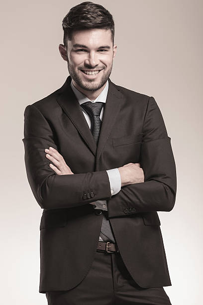 istock smiling young business man with hands crossed 508852979