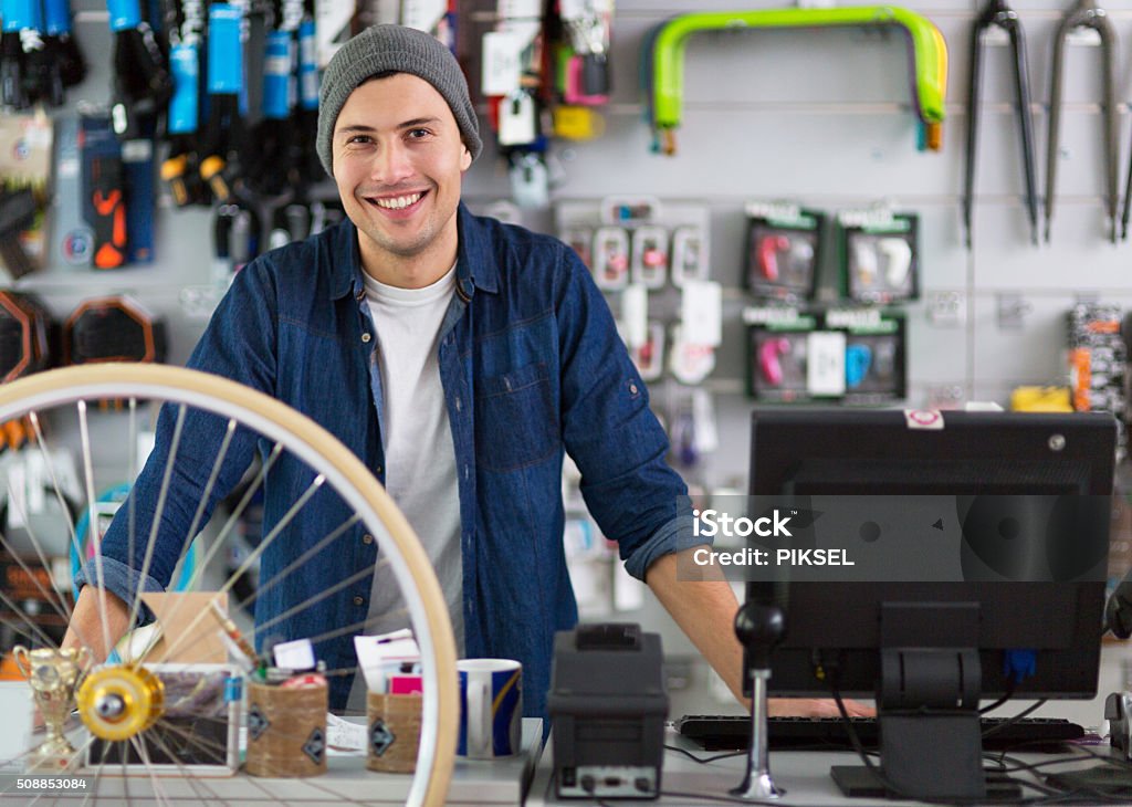 Salesman in bicycle shop Salesman in bicycle shop  Owner Stock Photo