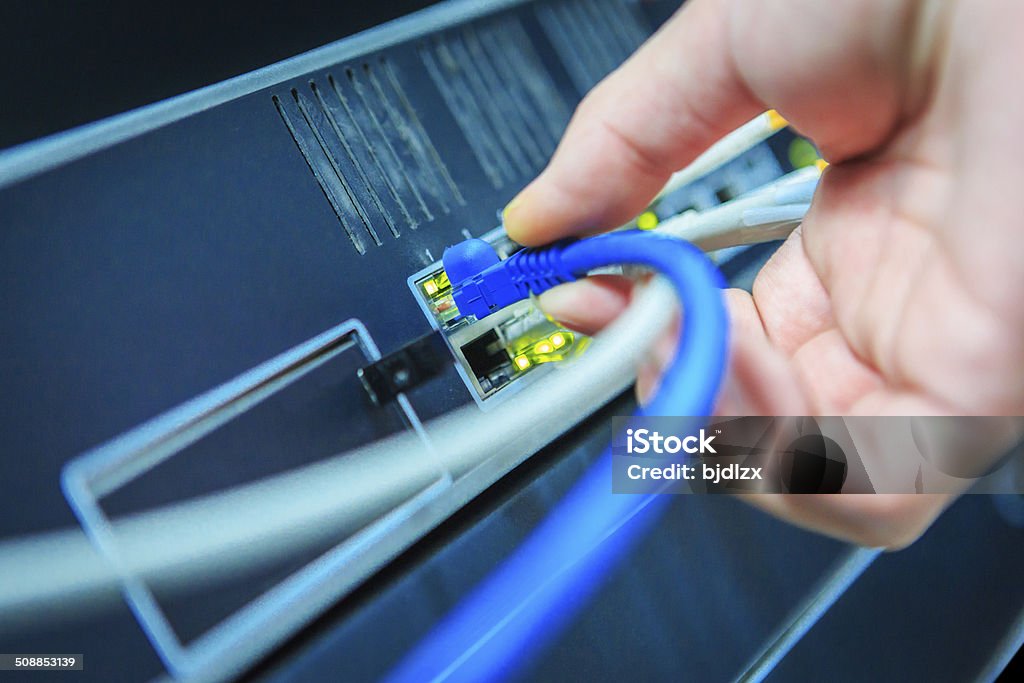 Network Tech checking a Telephone network card. Fiber Optic Stock Photo