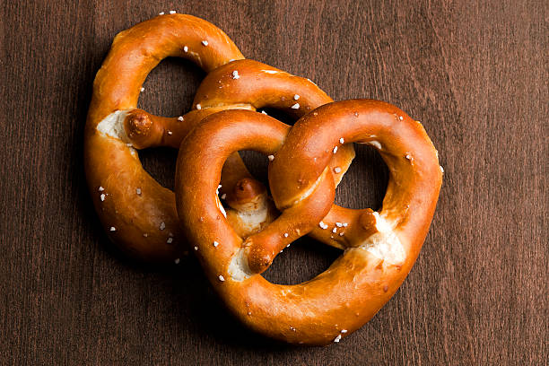 istock Two typical bavarian pretzel on a brown background 508854009