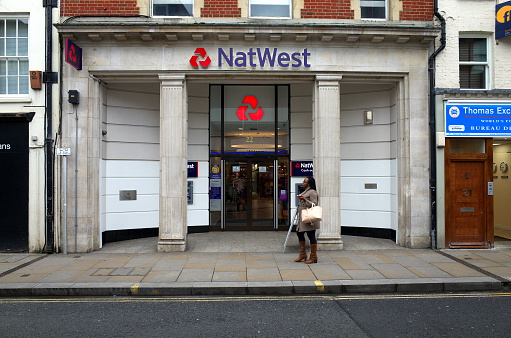 London, England - February 04, 2016: Pedestrian passing by the National Westminster Bank in Richmond, London. The NatWest as it is generally known is a member of the Royal Bank of Scotland Group