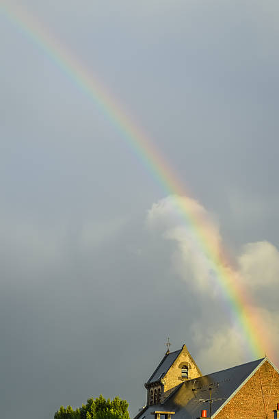 istock rainbow on a church roof 508855020