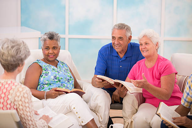 Senior adult friends, couple during bible study group. Group of senior adults during a bible study.  Multi-ethnic group reading bible together.  bible study group of people small group of people stock pictures, royalty-free photos & images