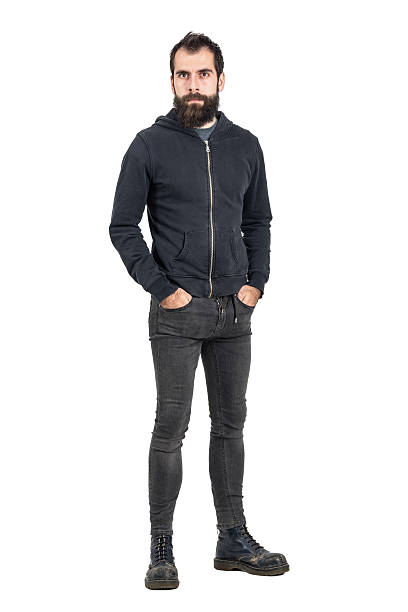 istock Tough confident punker in black hooded sweatshirt looking at camera 508856490