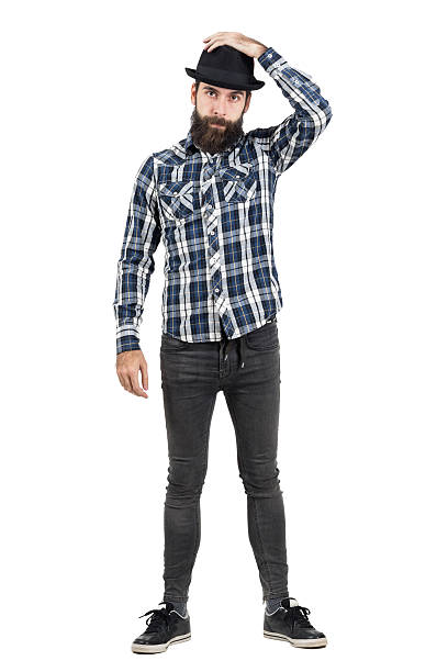 istock Bearded hipster putting on black fedora hat looking at camera 508856636