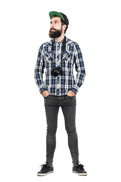Hipster wearing black dslr camera over neck looking away