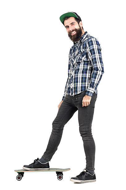 istock Laughing positive hipster with smiley piercing standing on skateboard 508856738