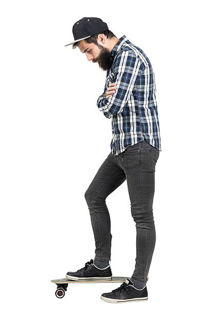 istock Hipster with crossed arms looking down standing on skate board 508856758